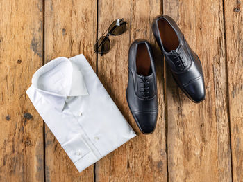 High angle view of shoes on wooden table