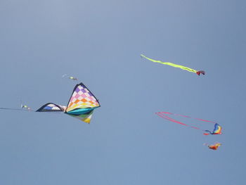 Low angle view of kite flying against clear sky