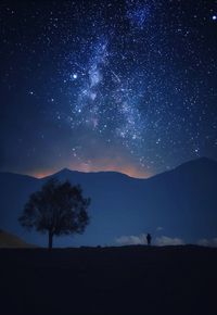 Majestic view of star field over landscape at night