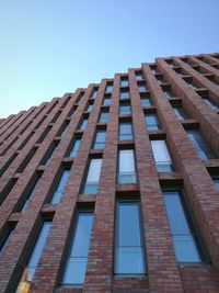 Low angle view of skyscraper against clear blue sky