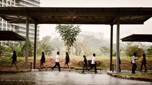 Group of people standing by built structure