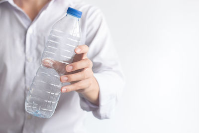 Midsection of man drinking glass