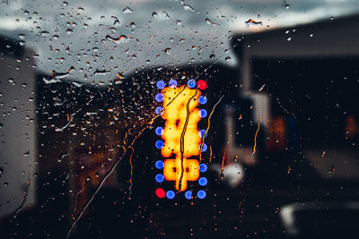 Close-up of wet glass window in rainy season