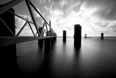 View of harbor against cloudy sky