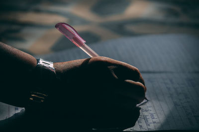 Close-up of hand holding cigarette