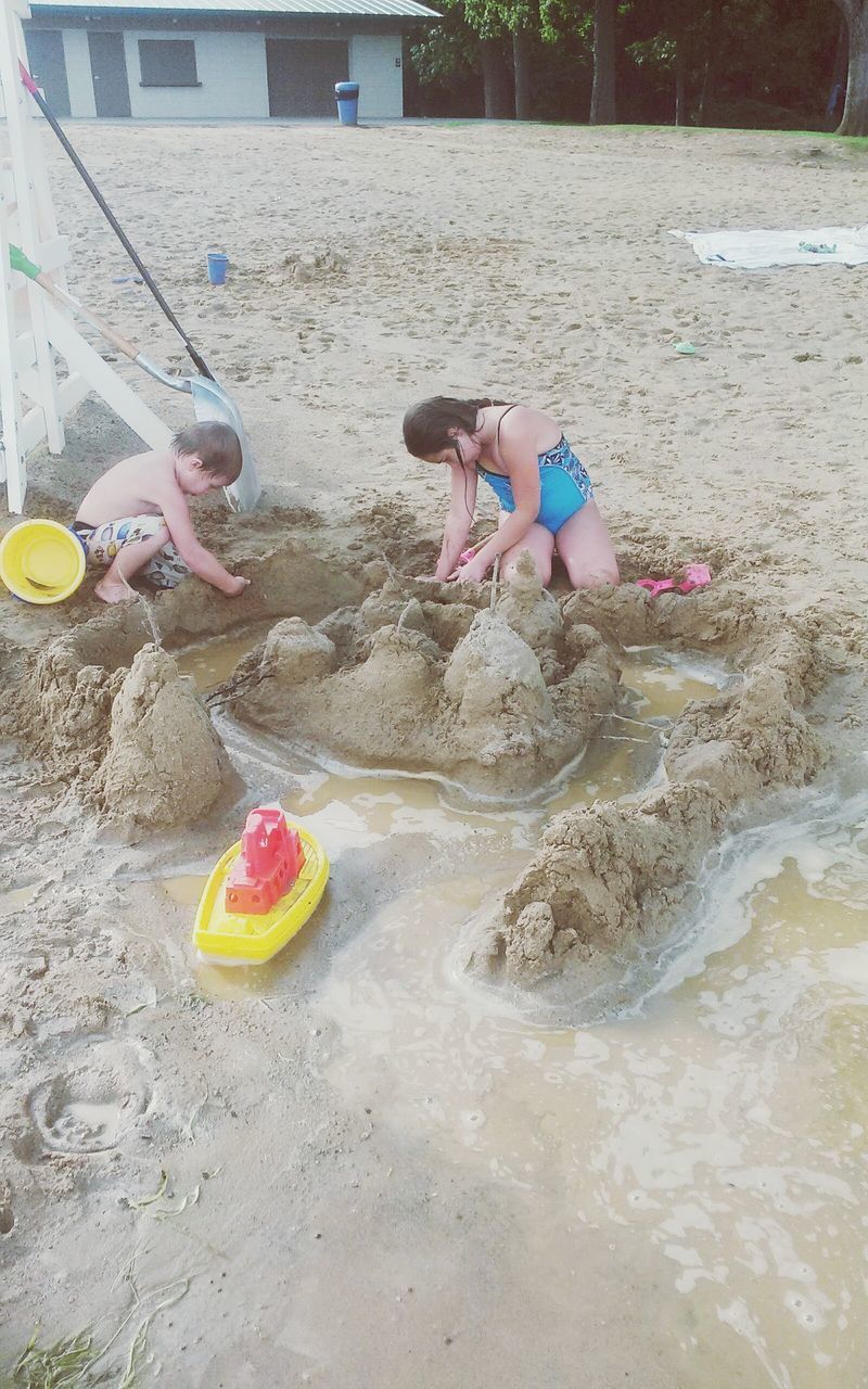 CHILDREN PLAYING ON SAND