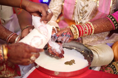 Cropped image of people practicing tradition during wedding ceremony