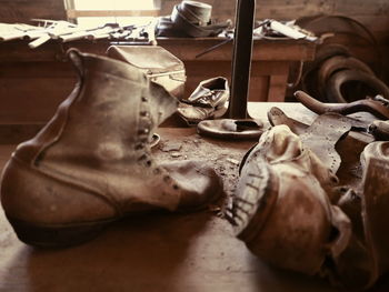 Close-up of abandoned leather shoes in workshop