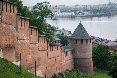 Old building by river in city