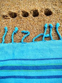 Close-up of blue fabric at beach