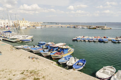 Boats moored at harbor