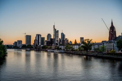 River with buildings in background at sunset