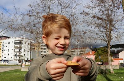 The blond boy narrowed his eyes and smiled, holding out a cookie in his hands.