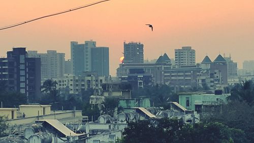 Buildings in city at sunset