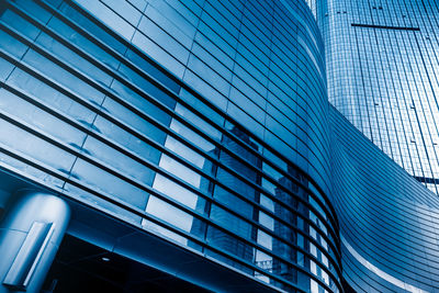 Low angle view of modern glass building in city