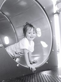 Cute girl looking away in tunnel at park