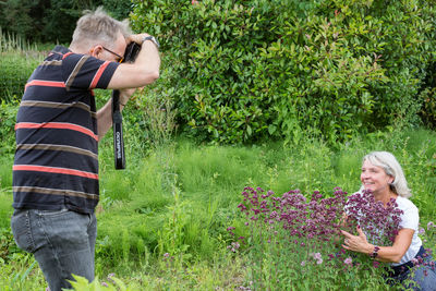 Woman standing by plants