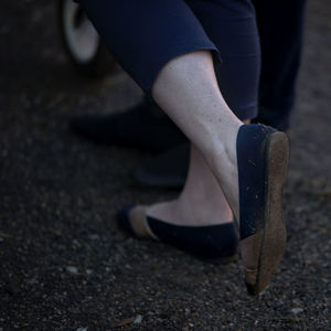 Low section of woman standing on street