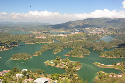 High angle view of sea and mountains against sky