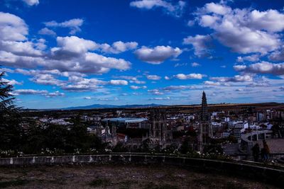 Scenic view of city against blue sky