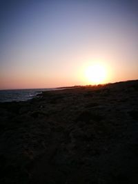 Scenic view of sea against clear sky during sunset