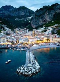 High angle view of sea and mountains against sky