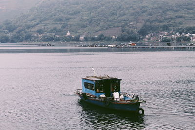 Fishing boat with a view of mountain at toba lake, north sumatra 