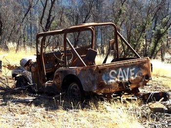 Panoramic shot of abandoned car on field