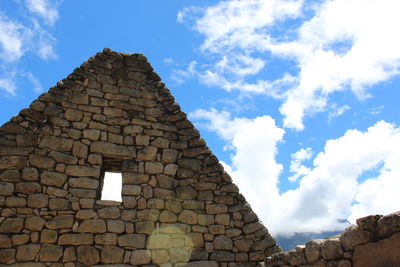 Low angle view of building against cloudy sky