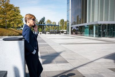 Full length of senior woman in city on sunny day