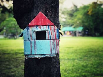 Close-up of wooden post on field against sky