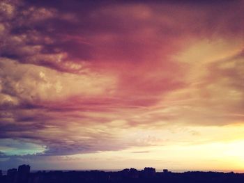 Silhouette of landscape against cloudy sky