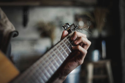 Cropped hand playing guitar