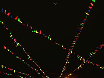 Low angle view of illuminated ferris wheel