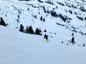 People skiing on snowcapped mountain