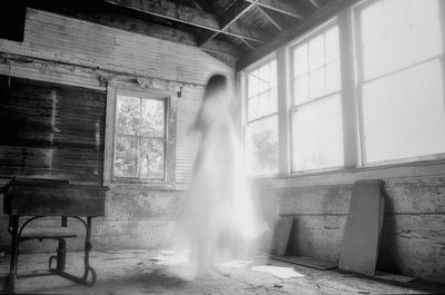 Woman standing by window