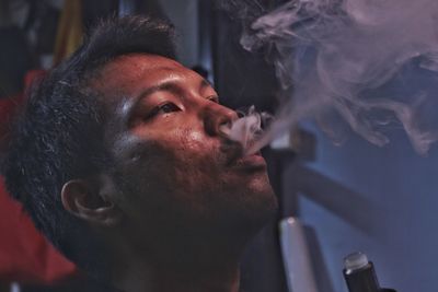 Portrait of man smoking cigarette