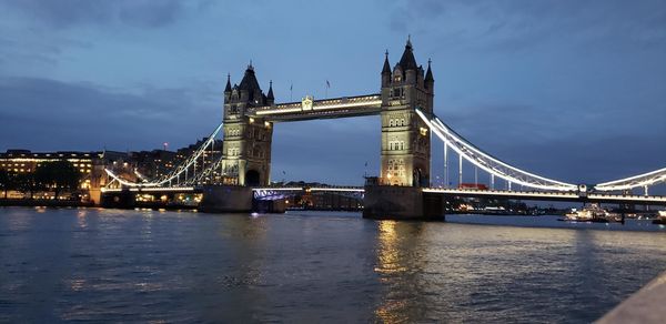 View of bridge over river against cloudy sky