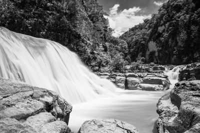 Scenic view of waterfall against rocks