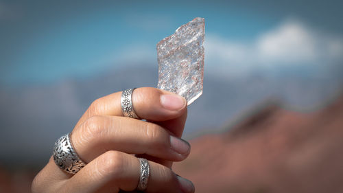 Cropped hand of person holding selenite