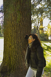 Woman standing on tree trunk