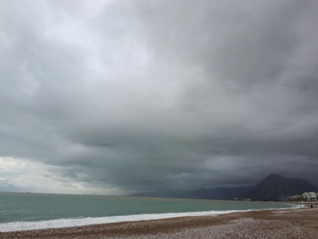 Scenic view of sea against storm clouds
