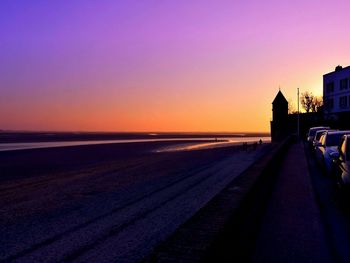 Scenic view of beach against clear sky during sunset