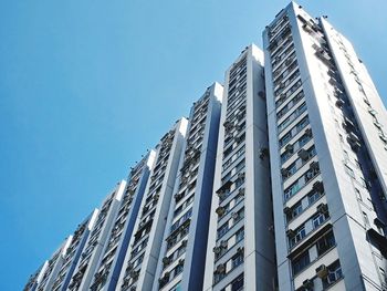 Low angle view of modern buildings against clear blue sky