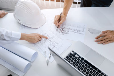 High angle view of man using laptop on table