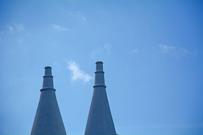 Low angle view of smoke stack against sky