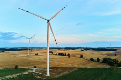 Windmill on field against sky