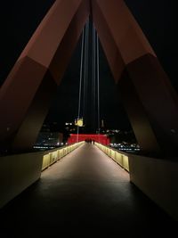 Illuminated bridge against sky in city at night
