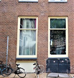 Bicycle against building in city