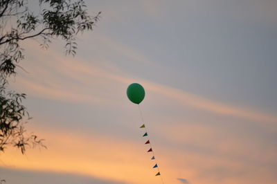 Hot air balloons flying against sky during sunset